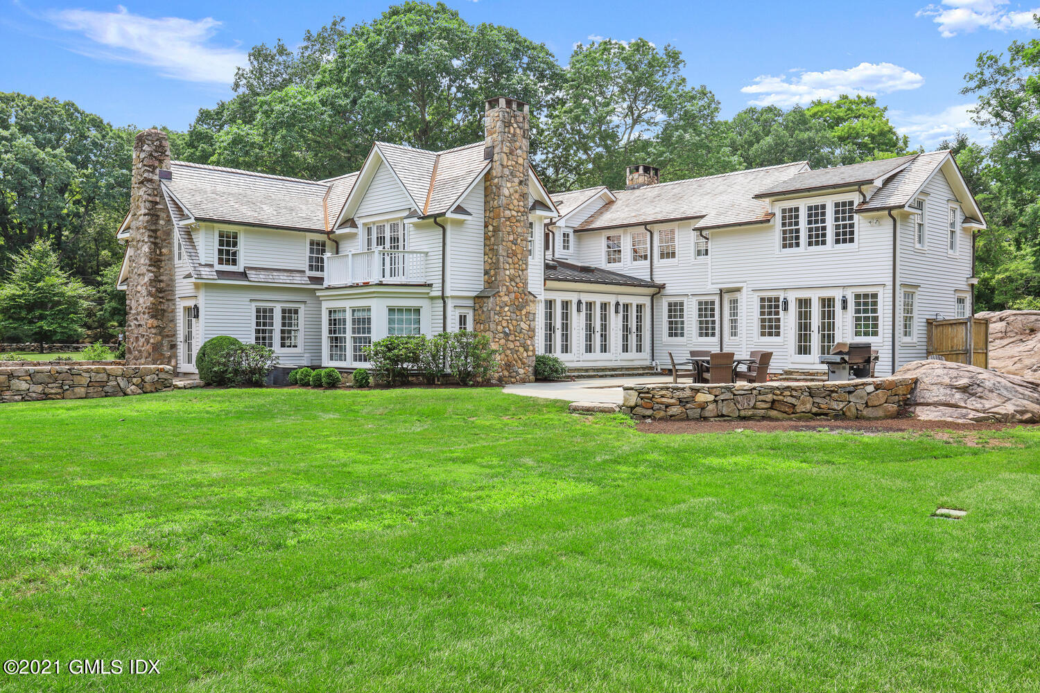 175 Cat Rock Road Cos Cob, CT 06807 - Photo 53 of 72 a front view of a house with yard and green space