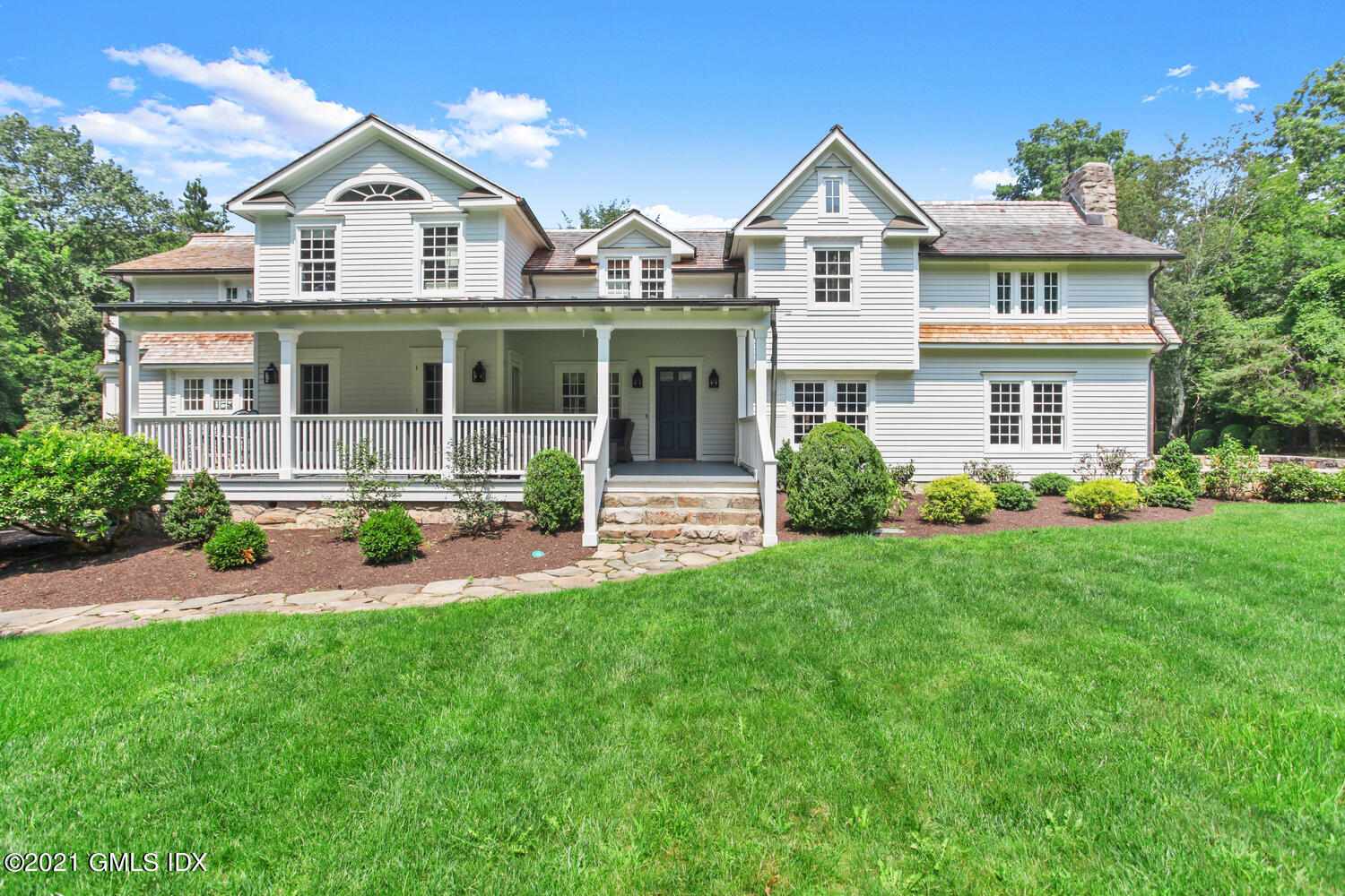 175 Cat Rock Road Cos Cob, CT 06807 - Photo 62 of 72 a front view of a house with a yard and potted plants