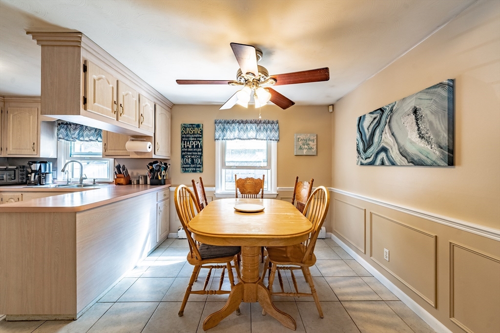241 Mallowhill Road Springfield, MA 01129 - Photo 8 of 34 a dining room with stainless steel appliances a table and chairs