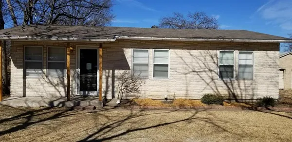 a view of a house with a wooden bench