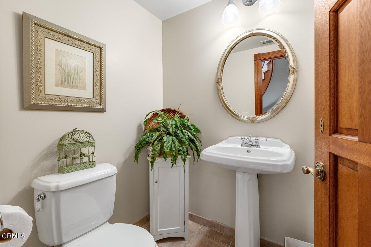 2300 Peninsula Road Oxnard, CA 93035 - Photo 14 of 54 a bathroom with a toilet a sink and a mirror
