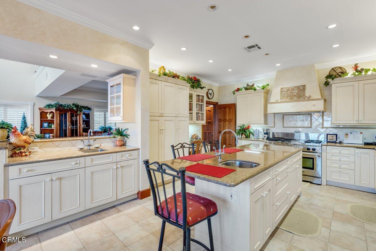 2300 Peninsula Road Oxnard, CA 93035 - Photo 19 of 54 a kitchen that has a lot of cabinets in it and wooden floors
