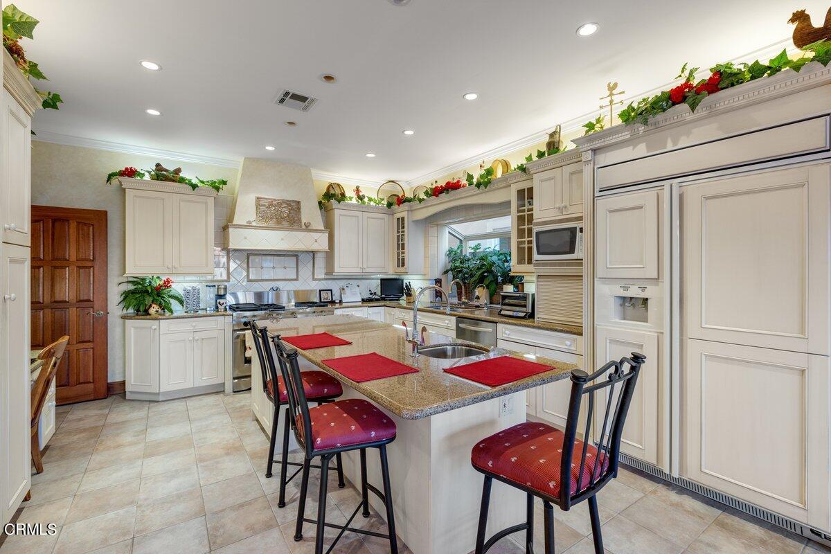2300 Peninsula Road Oxnard, CA 93035 - Photo 21 of 54 a kitchen with stainless steel appliances kitchen island granite countertop a refrigerator and a dining table
