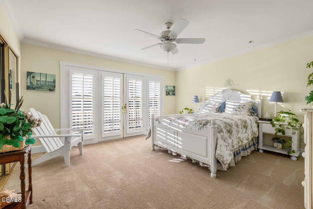 2300 Peninsula Road Oxnard, CA 93035 - Photo 28 of 54 a spacious bedroom with a bed and a chandelier