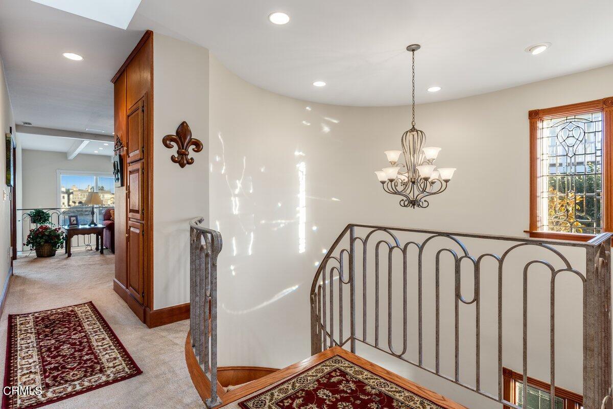 2300 Peninsula Road Oxnard, CA 93035 - Photo 30 of 54 a view of staircase with kitchen view and wooden floor