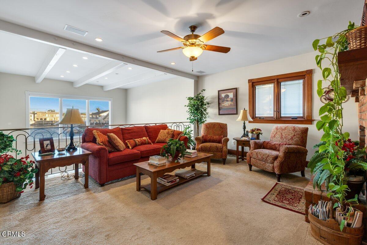 2300 Peninsula Road Oxnard, CA 93035 - Photo 31 of 54 a living room with furniture plant and a chandelier