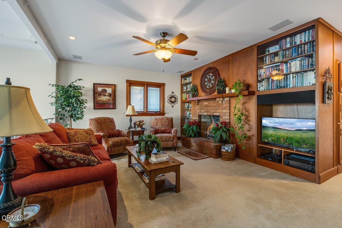 2300 Peninsula Road Oxnard, CA 93035 - Photo 32 of 54 a living room with furniture a fireplace and a large window