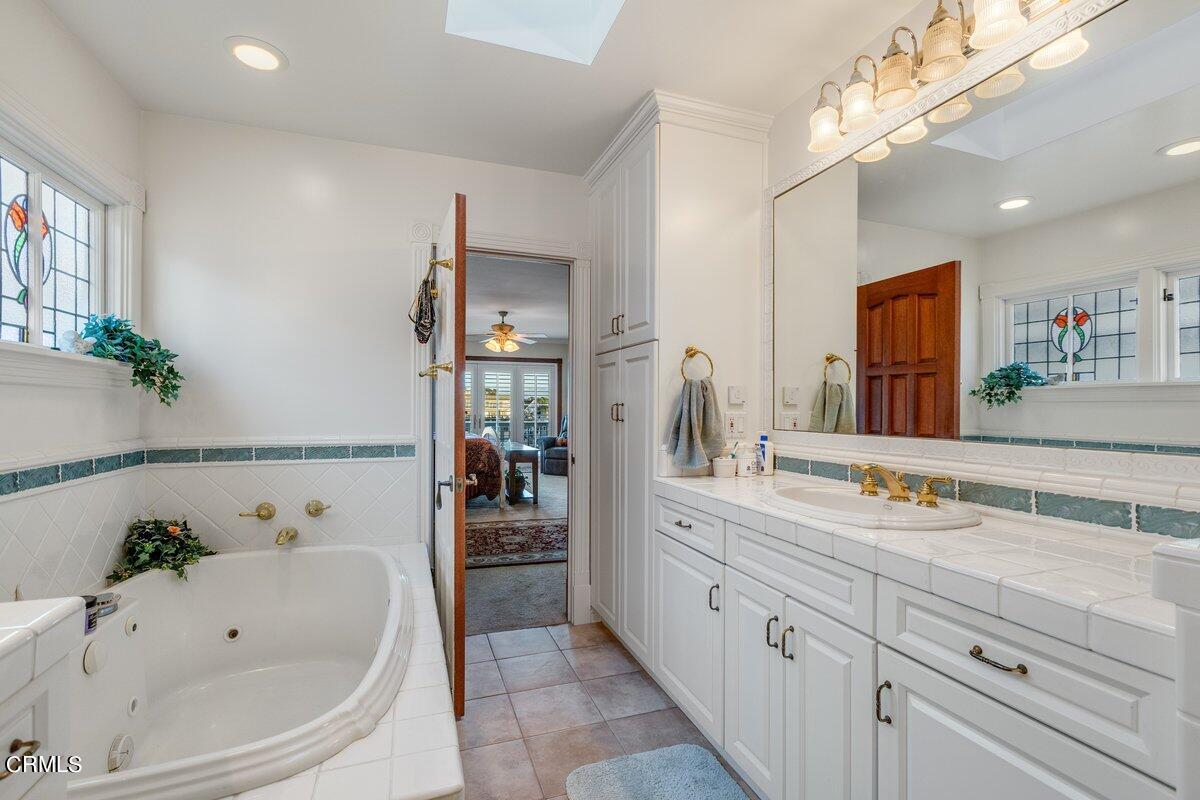 2300 Peninsula Road Oxnard, CA 93035 - Photo 39 of 54 a spacious bathroom with a tub sink and mirror