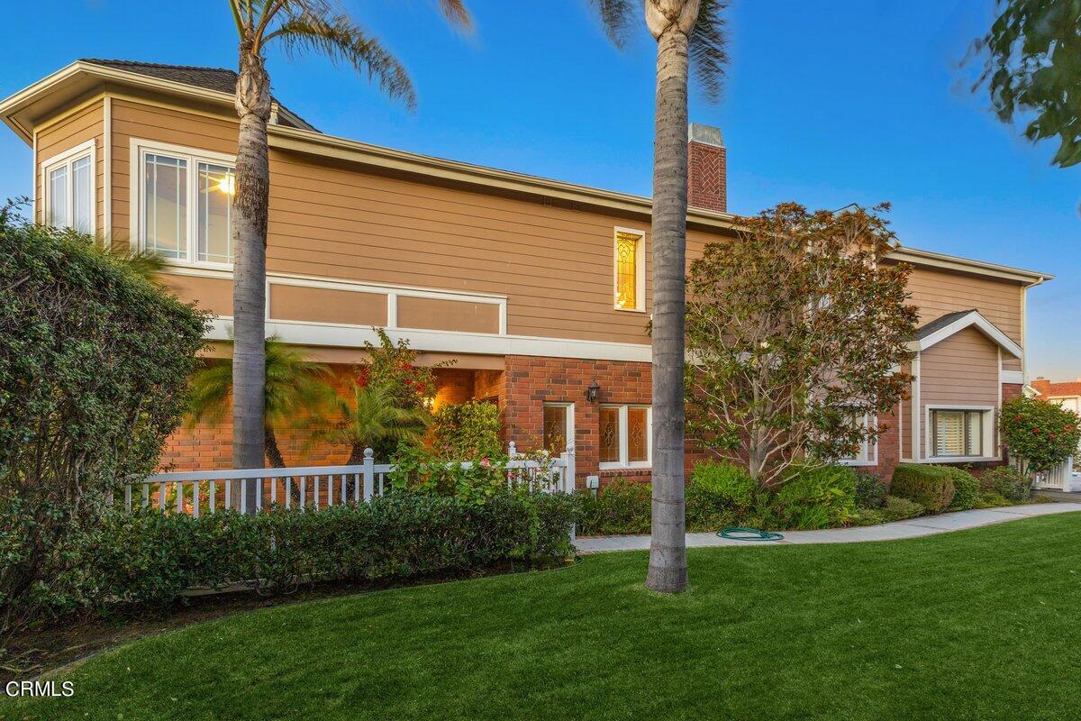 2300 Peninsula Road Oxnard, CA 93035 - Photo 6 of 54 a view of a house with brick walls and a yard with plants