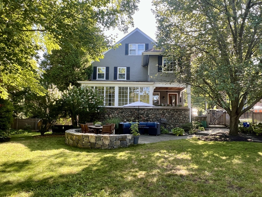 a front view of a house with a yard table and chairs