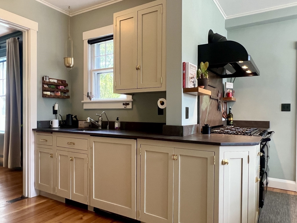 211 Forest Street Winchester, MA 01890 - Photo 12 of 41 a kitchen with white cabinets and a sink
