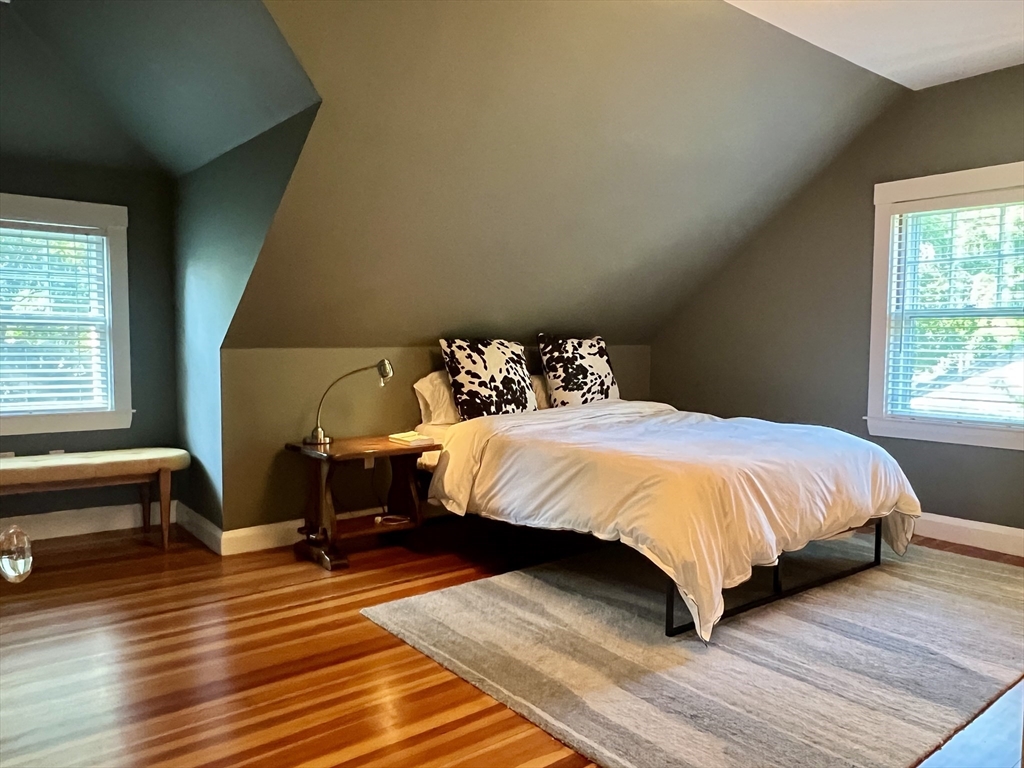 211 Forest Street Winchester, MA 01890 - Photo 27 of 41 a bedroom with a bed and wooden floor