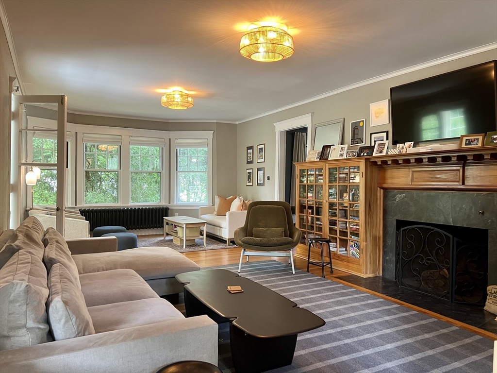 211 Forest Street Winchester, MA 01890 - Photo 3 of 41 a living room with furniture a flat screen tv and a fireplace