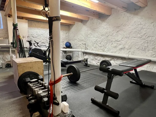 a view of a patio with couches and chairs under an umbrella