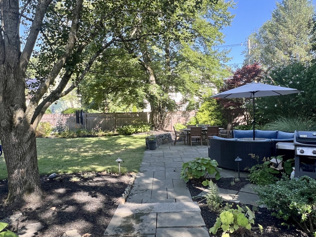 211 Forest Street Winchester, MA 01890 - Photo 33 of 41 a view of a garden with a bench