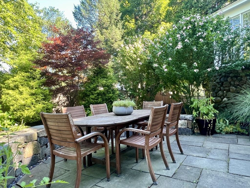 211 Forest Street Winchester, MA 01890 - Photo 35 of 41 a view of a dining table and chairs in the patio