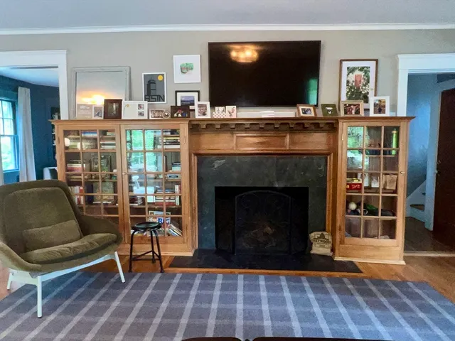 a living room with furniture a flat screen tv and a fireplace