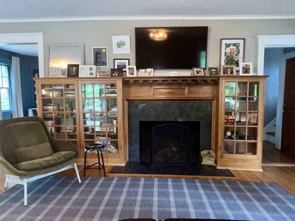 211 Forest Street Winchester, MA 01890 - Photo 7 of 41 a living room with furniture a flat screen tv and a fireplace