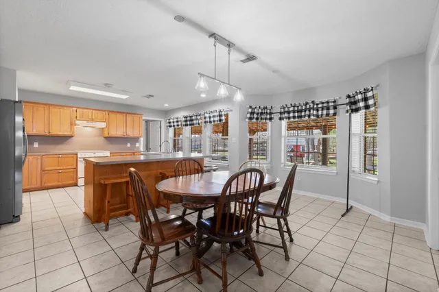 a dining area with furniture and window