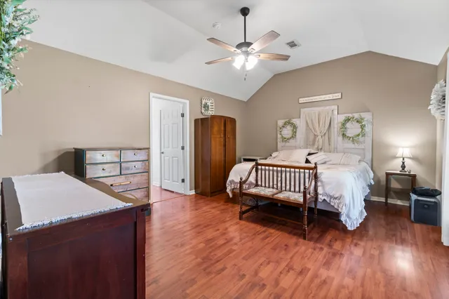 a bedroom with a bed and wooden floor