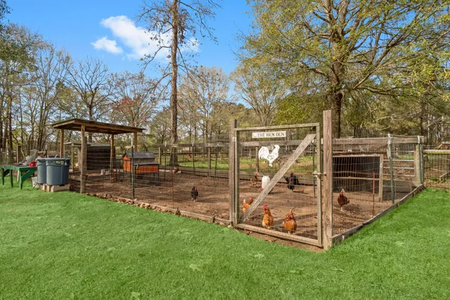a view of a wooden deck and a yard with the bench