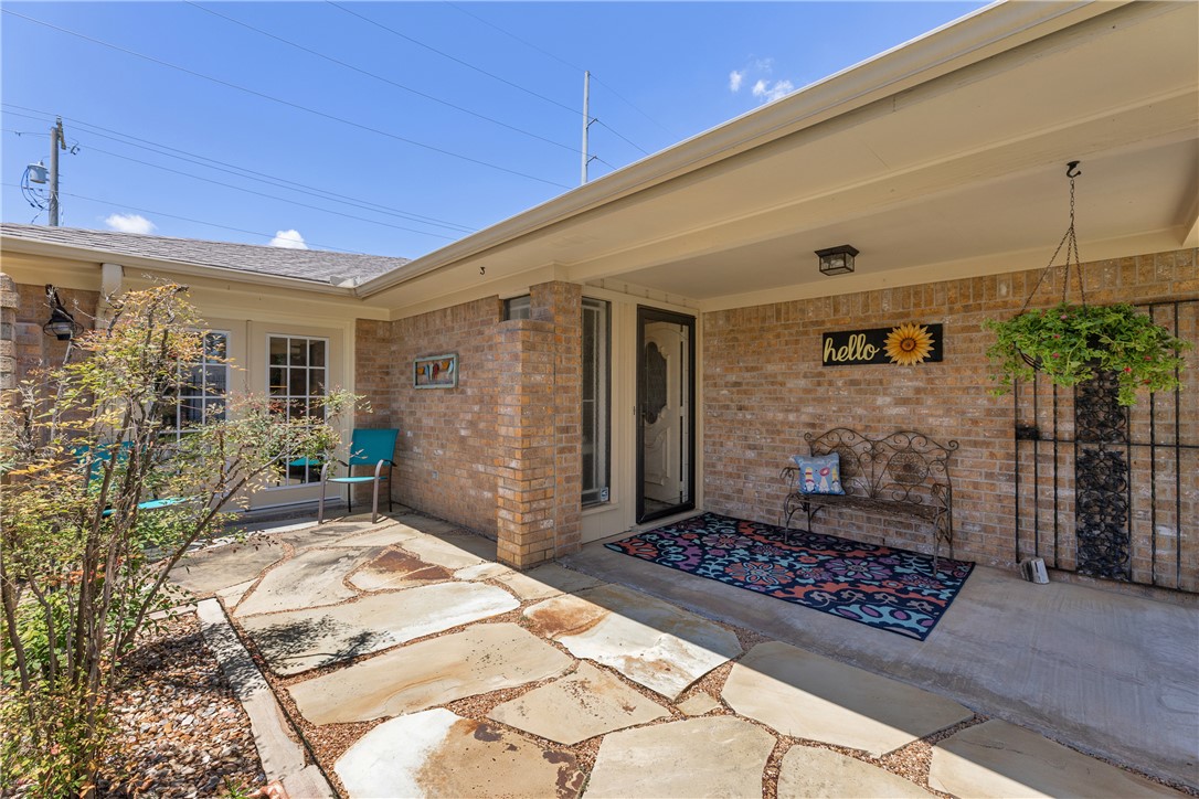 2911 Braeburn Street Bryan, TX 77802 - Photo 5 of 30 Covered Front Entry and Stone Patio Area for outdoor enjoyment.