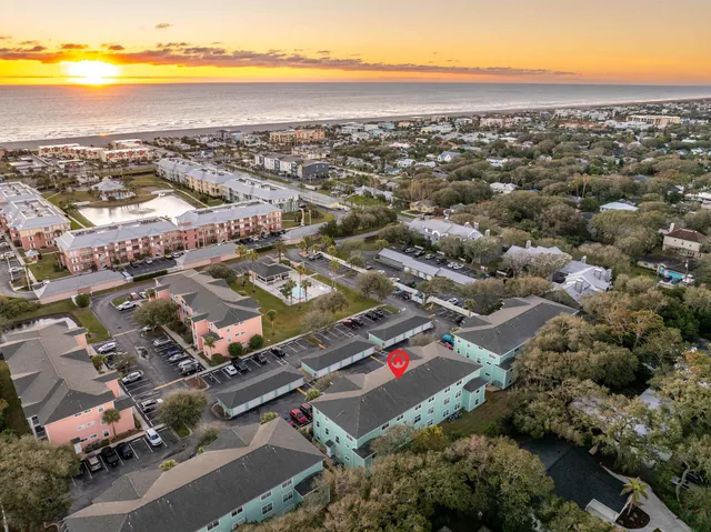 an aerial view of residential building and ocean