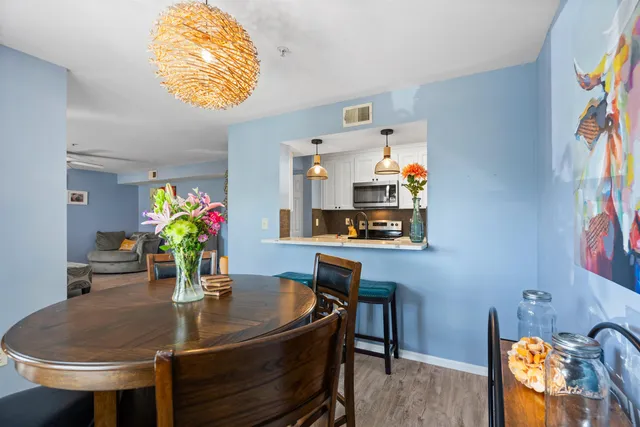 a dining room with furniture and wooden floor