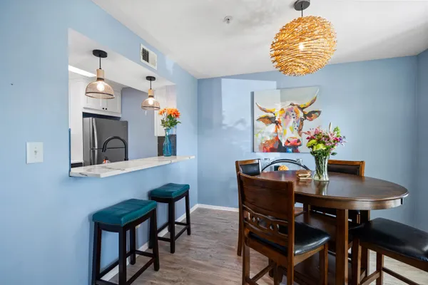 a view of a dining room with furniture and chandelier