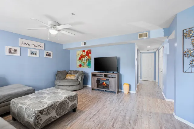 a bedroom with furniture and a flat screen tv