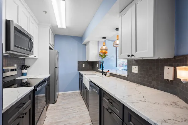 a kitchen with a sink stove top oven and cabinets