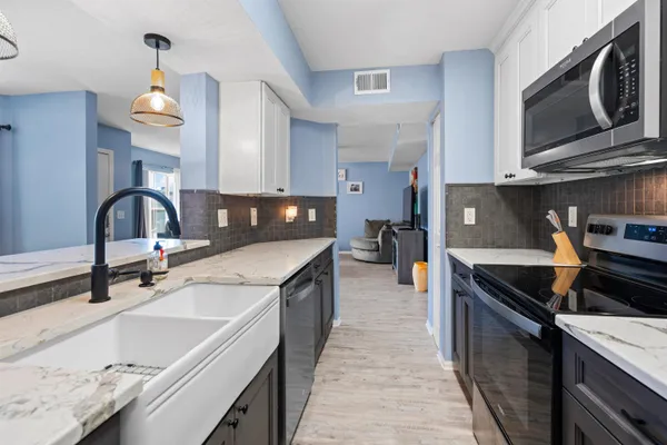 a kitchen with a sink stove and microwave
