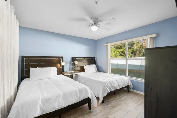 a bedroom with two beds and a chandelier