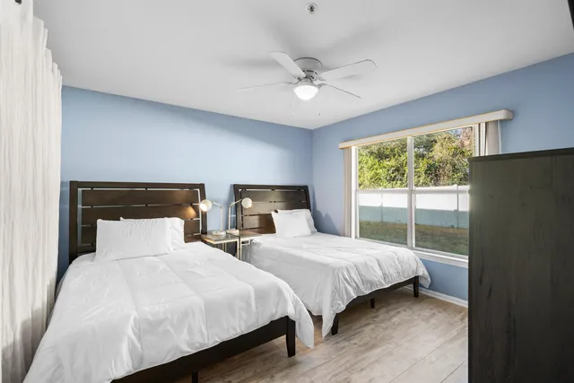a bedroom with two beds and a chandelier