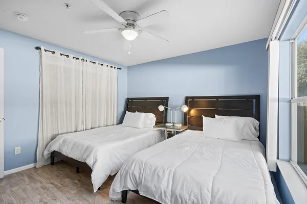 a bedroom with two beds and a chandelier