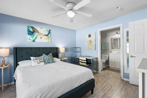 a bedroom with a bed and a chandelier