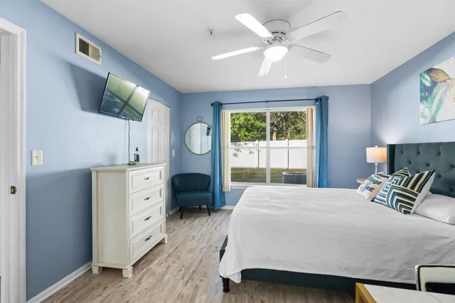 a bedroom with a bed mirror and a window