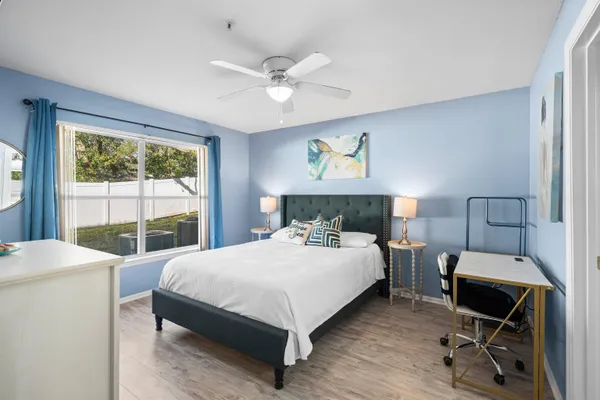 a bedroom with a bed and a large window