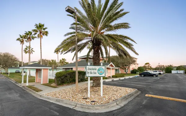 a view of a swimming pool with a table and chairs