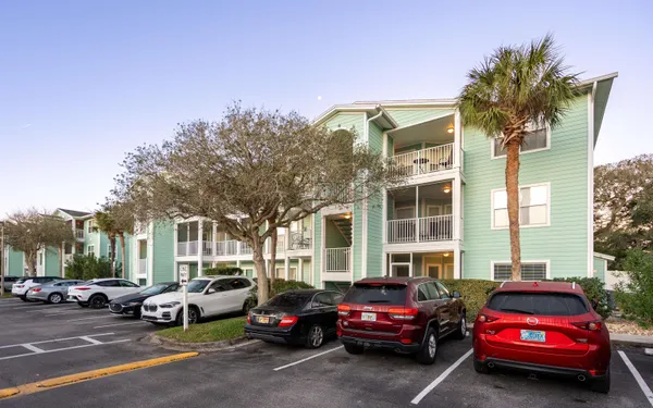 a car parked in front of a white building