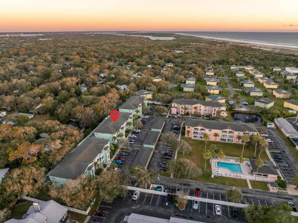 an aerial view of residential houses with city view