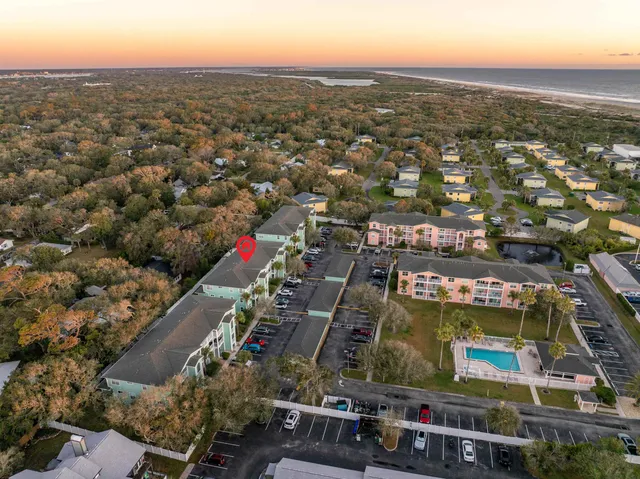 an aerial view of residential houses with city view