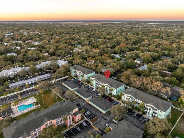 an aerial view of residential houses with outdoor space