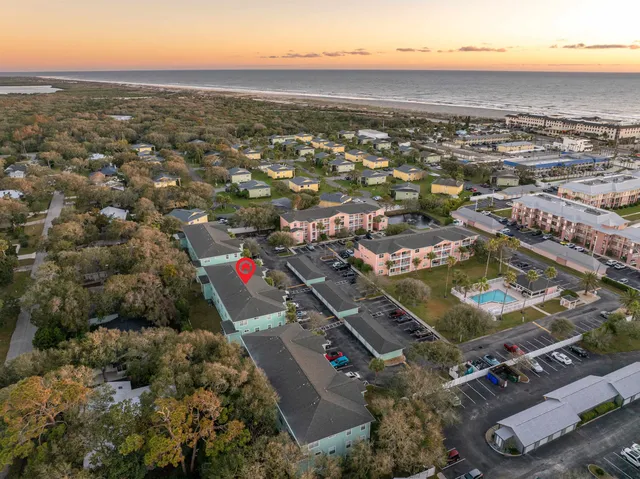 an aerial view of residential houses with city view