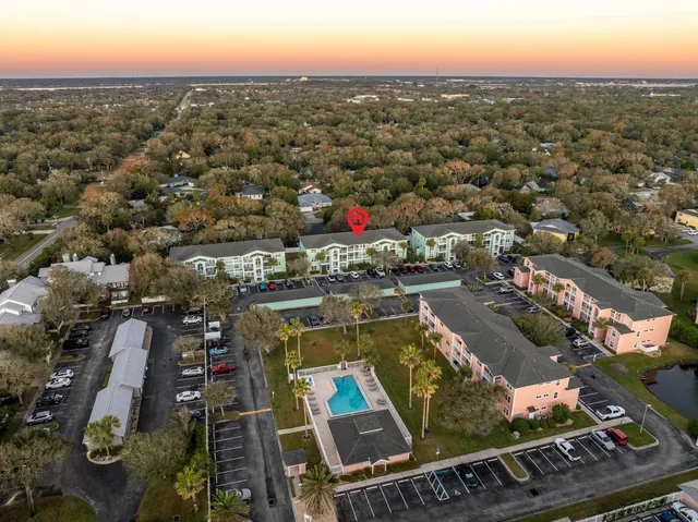 an aerial view of residential houses with city view