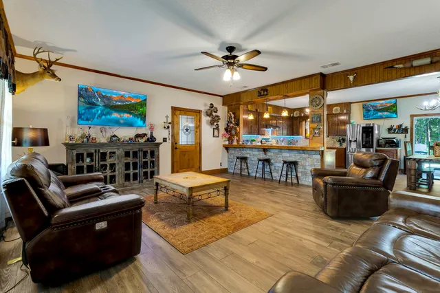 a living room with fireplace furniture and a flat screen tv