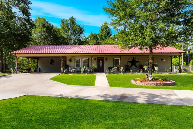 a front view of a house with a yard table and chairs