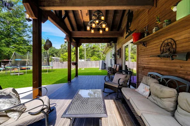 a view of yard from deck with patio