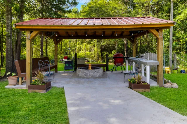 a view of a patio with a table and chairs under an umbrella