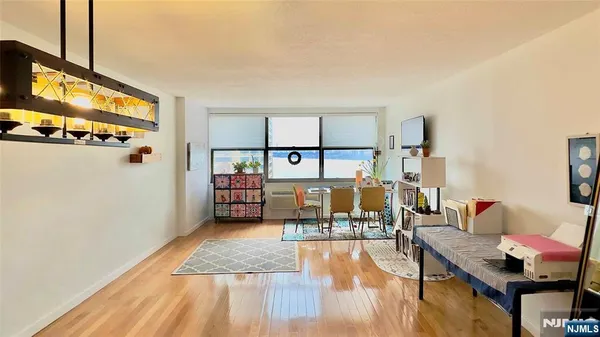 a living room with furniture and a floor to ceiling window